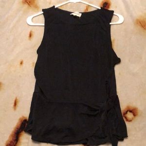 Méralo sleeveless blouse. Sheer lightweight with a side tie near the hip Size L